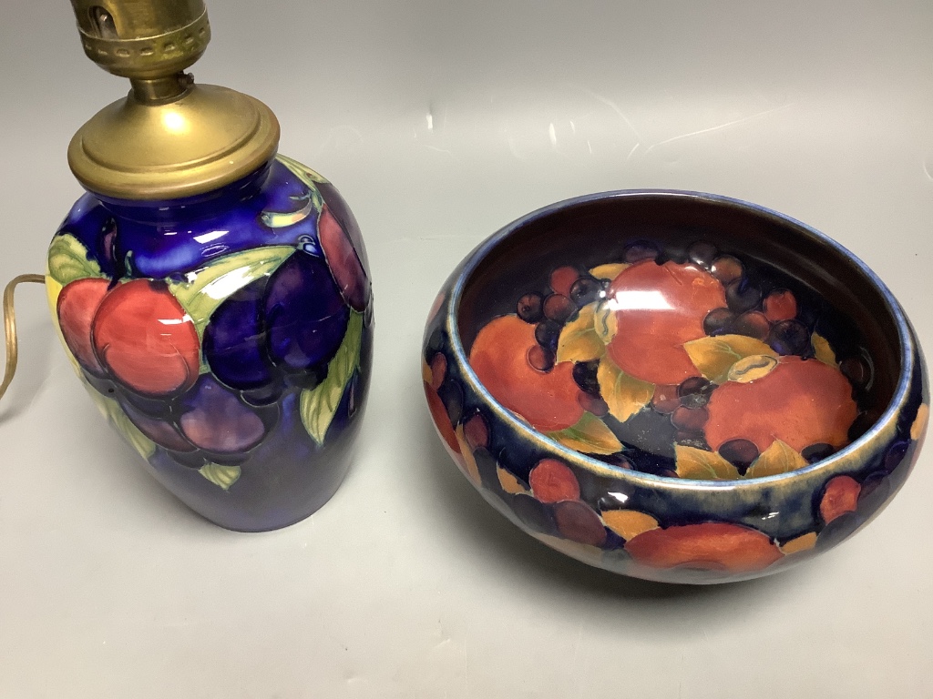 A small Moorcroft wisteria pattern table lamp base, height 16.5cm not including light fitting, and a Moorcroft Pomegranate pattern bowl